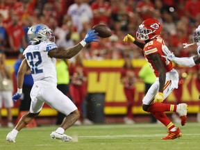 Brian Branch of the Detroit Lions intercepts a pass intended for Kadarius Toney of the Kansas City Chiefs.
