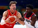 Moritz Wagner of Germany drives to the basket against Jaren Jackson Jr. of the United States in the fourth quarter during the FIBA Basketball World Cup semifinal.
