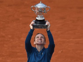 Romania's Simona Halep poses with her trophy, after winning the women's singles final match against Sloane Stephens at The 2018 French Open.