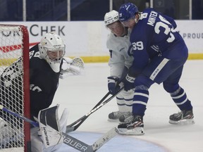 Toronto Maple Leafs prospect Fraser Minten (right) take part in practice.