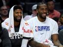 Paul George (left) and Kawhi Leonard of the LA Clippers laugh on the bench.