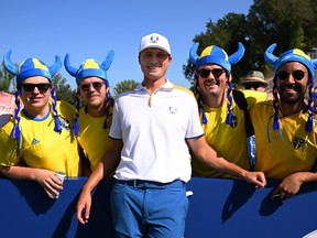 Ludvig Aberg of Team Europe poses with Swedish fans on the sixth hole during a practice round.