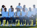 Rory McIlroy is lifted up by Shane Lowry as the European Team assemble for their team photo.