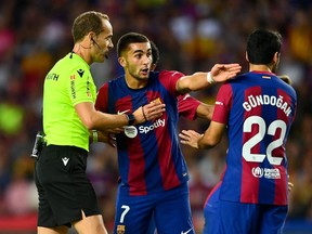 Barcelona forward Ferran Torres argues with referee Mario Melero Lopez.