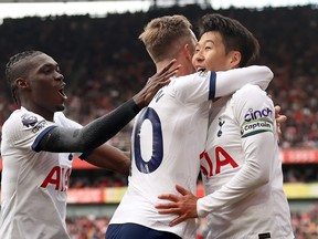 Tottenham Hotspur's Heung-Min Son celebrates with James Maddison after scoring the team's second goal against Arsenal.