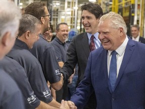 Prime Minister Justin Trudeau and Premier Doug Ford greet workers at the Cami auto plant in Ingersoll.