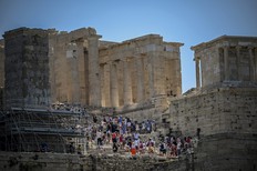 Tourists visit the Ancient Acropolis archeological site in Athens on July 13, 2023.