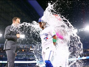 Bo Bichette of the Toronto Blue Jays is doused with water.