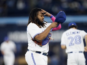 Vladimir Guerrero Jr. #27 of the Toronto Blue Jays puts on his hat after hitting a pop fly to end the sixth inning of their MLB game against the Texas Rangers at Rogers Centre on September 13, 2023 in Toronto. (Photo by Cole Burston/Getty Images)