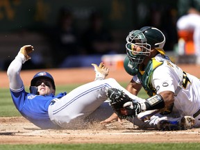 Blue Jays' Cavan Biggio scores sliding past catcher Carlos Perez of the Athletics in the top of the second inning at RingCentral Coliseum on Wednesday, Sept. 6, 2023 in Oakland.