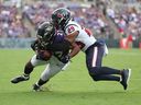 J.K. Dobbins #27 of the Baltimore Ravens is tackled by M.J. Stewart #29 of the Houston Texans during the second half at M&T Bank Stadium on September 10, 2023 in Baltimore, Maryland.