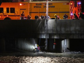 Clark County Fire Department officials searche for a man who was trapped in floodwaters in a flood channel Friday, Sept. 1, 2023, in Las Vegas.