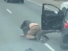 Screenshot of two men wrestling on Hwy. 401 near Leslie St. in road rage incident.