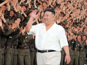 This picture taken on September 10, 2023 and released from North Korea's official Korean Central News Agency (KCNA) on September 11, 2023 shows North Korea's leader Kim Jong Un (C) posing for a commemorative photo with participants of a military parade on the 75th anniversary of the founding of the nation, at an undisclosed location. (Photo by KCNA VIA KNS / AFP)