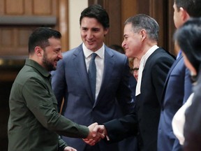 Ukrainian President Volodymyr Zelensky, left, with Prime Minister Justin Trudeau (centre), shake hands with House of Commons Speaker Anthony Rota during a ceremony on Parliament Hill in Ottawa, Sept. 22, 2023.