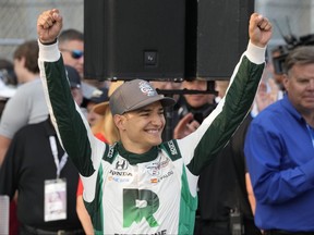 Alex Palou acknowledges fans after winning the IndyCar Detroit Grand Prix auto race, Sunday, June 4, 2023, in Detroit