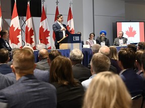 Conservative Leader Pierre Poilievre speaks to his caucus as he meets them prior to the Conservative convention, in Quebec City, Thursday, Sept. 7, 2023.