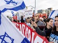 Protesters rally outside Tesla's Fremont, Calif., factory