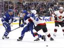 Maple Leafs' Tyler Bertuzzi battles with Ottawa Senators' Jakob Chychrun during  pre-season action in Toronto on Monday, Sept. 25, 2023. 