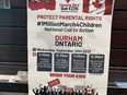 A poster announces a planned protest next week against gender ideology teachings in classrooms in Durham Region.