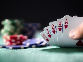 This file photo shows a poker player holding a winning royal flush hand of cards.