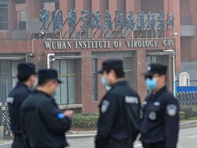 Security personnel stand guard outside the Wuhan Institute of Virology in Wuhan