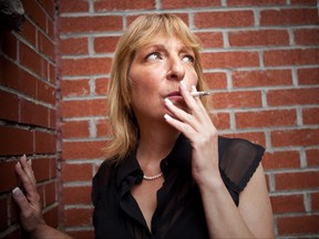 Woman smoking outside a building