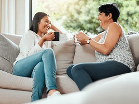Shot of a senior woman bonding with her daughter on the sofa at home