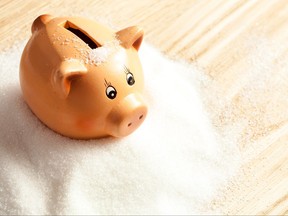 Piggy bank in a pile of white sugar.