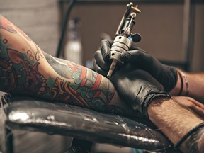Close up of tattoo artist tattooing someone's arm.