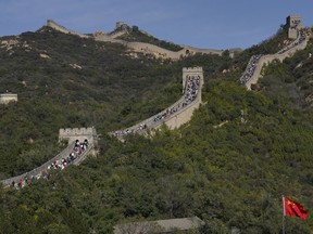 Tourists climb up a stretch of the Great Wall of China