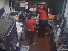 Security camera footage from March 2021 showed a Jack in the Box worker, right, pull out a gun and fired it at a customer during a dispute over an order.