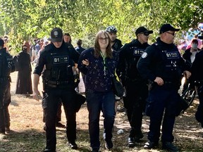 Toronto Police arrest Julia Stevenson at Queen's Park on Wednesday, Sept. 20, 2023. Joe Warmington/Toronto Sun