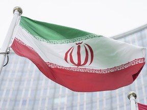 The flag of Iran waves in front of the the International Center building with the headquarters of the International Atomic Energy Agency