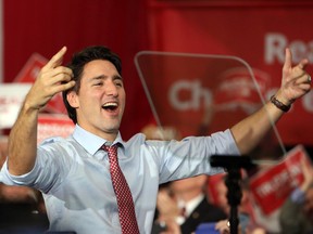 Justin Trudeau cheering with hands in the air