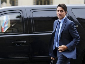 Justin Trudeau on street in front black SUV