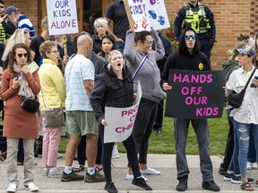 People protesting "gender-affirming policies" in schools are shown outside the Thames Valley District school board headquarters on Dundas Street. Photo taken Sept. 20, 2023. (Derek Ruttan/The London Free Press)