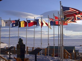 Flags of the original 12 signatory nations of the Antarctic Treaty fly next to a bust of Admiral Richard Byrd at McMurdo Station on Oct. 21, 2005 in Antartica.