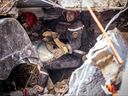 Rescue workers search for survivors in a collapsed house in Moulay Brahim, Al Haouz province, on Sept. 9, 2023, after an earthquake. 