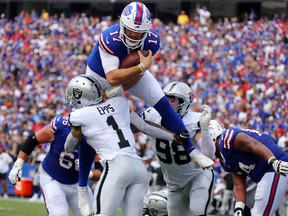 Buffalo Bills Josh Allen tries to leap over other players