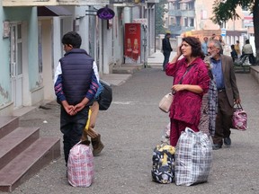 Local residents stand in a street in the town of Stepanakert on Sept. 25, 2023.