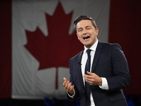 Conservative Leader Pierre Poilievre with a Canadian flag in the background