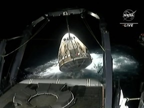 SpaceX Crew Dragon Endeavour spacecraft being lifted onto the recovery vessel