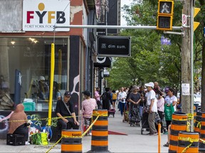 A line stretches down the block in front of the Fort York Food Bank on College St.