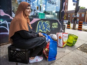Shahnaz sits outside of Fort York Food Bank on College St., near Kensington Market, in Toronto on Thursday, Sept. 7, 2023.