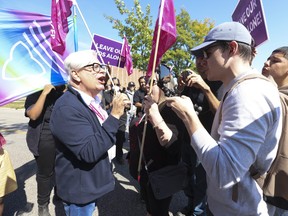 Counter protestors get in the face of Fred Hahn, (L) president of CUPE Ontario, as a large group of pro-2SLGBTQ+ rights advocates staged a day-long rally outside Victoria Park C.I. in North York on Friday, Sept. 22, 2023.