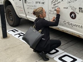 Tamara Lich signs a pickup truck in downtown Ottawa on Thursday, Sept 14, 2023.