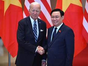 Chairman of Vietnam's National Assembly Vuong Dinh Hue, right, shakes hands with U.S. President Joe Biden during a meeting at the National Assembly in Hanoi, Monday, Sept. 11, 2023.