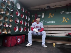 Los Angeles Angels' Shohei Ohtani sits in the dugout before a baseball game against the Oakland Athletics in Oakland, Calif., Saturday, Sept. 2, 2023.