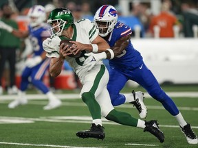 New York Jets quarterback Aaron Rodgers (8) is sacked by Buffalo Bills defensive end Leonard Floyd (56) during the first quarter of an NFL football game, Monday, Sept. 11, 2023, in East Rutherford, N.J.